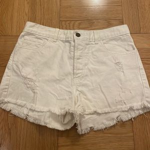 Distressed white jean shorts